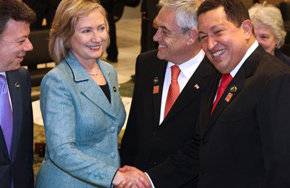 Hillary Clinton saluda a Hugo Chávez durante su encuentro con motivo de la transmisión de mando en Brasil esta misma semana