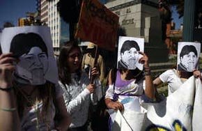 Manifestantes portan en sus rostros fotografías del presidente Evo Morales