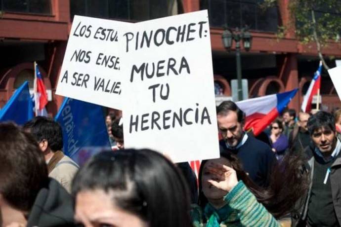 Una manifestante muestra un cartel en contra en Pinochet durante una marcha en septiembre de 2011.
