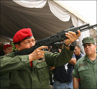 En una imagen de archivo, el presidente de Venezuela Hugo Chávez prueba un fusil ametralladora ruso, AK-103, en el año 2006. 

