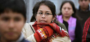 Una joven se protege del frío en una calle de Lima (Perú)